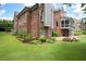 Brick home's backyard featuring lush greenery, a stone patio, and an outdoor fire pit at 2260 Falkirk Pointe Dr, Marietta, GA 30062