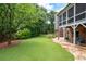 Expansive backyard with a fire pit, seating area, and mature landscaping at 2260 Falkirk Pointe Dr, Marietta, GA 30062