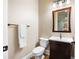 Stylish powder room featuring a modern vanity, wood-framed mirror, and a neutral color palette at 2260 Falkirk Pointe Dr, Marietta, GA 30062