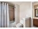 Clean bathroom featuring a shower with tile surround, a toilet, and a vanity visible in the doorway at 2260 Falkirk Pointe Dr, Marietta, GA 30062