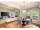 Bright dining area with hardwood floors, modern chandelier, and views of the outdoor deck and backyard at 2260 Falkirk Pointe Dr, Marietta, GA 30062