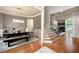 Open-concept view of the dining and living rooms, showcasing hardwood floors and lots of natural light at 2260 Falkirk Pointe Dr, Marietta, GA 30062