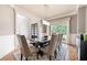 Elegant dining area featuring a large table, modern lighting, and a view to the front yard at 2260 Falkirk Pointe Dr, Marietta, GA 30062