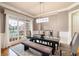 Stylish dining room with modern light fixture, wainscoting, and large window offering abundant natural light at 2260 Falkirk Pointe Dr, Marietta, GA 30062