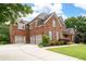 Charming brick home featuring a three-car garage and well-manicured landscaping at 2260 Falkirk Pointe Dr, Marietta, GA 30062