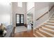 Elegant foyer with hardwood floors, a staircase, and a view into a bright, inviting living space at 2260 Falkirk Pointe Dr, Marietta, GA 30062