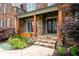 Welcoming entrance featuring stone accents, wooden pillars, and a beautifully landscaped walkway to the front door at 2260 Falkirk Pointe Dr, Marietta, GA 30062