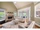 Cozy living room with stone fireplace that offers seamless flow into the dining area and kitchen at 2260 Falkirk Pointe Dr, Marietta, GA 30062