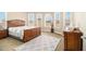 Bedroom with carpeting and a bed set with a dark wood frame and three windows allowing ample natural light at 3621 Guinevere Trce, Douglasville, GA 30135