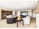 Spacious living room featuring a decorative bookshelf, entertainment center, and comfortable seating arrangement at 3621 Guinevere Trce, Douglasville, GA 30135