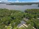 Aerial view of a home in a serene neighborhood surrounded by lush greenery and a lake at 401 Cottonwood Dr, Woodstock, GA 30189