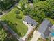 Aerial view of a home featuring lush green landscaping and mature trees at 401 Cottonwood Dr, Woodstock, GA 30189