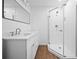 Modern bathroom featuring dual vanity, granite countertop, and a large shower at 401 Cottonwood Dr, Woodstock, GA 30189