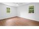 Bright bedroom with hardwood flooring and natural light from the energy-efficient windows at 401 Cottonwood Dr, Woodstock, GA 30189