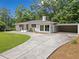 Charming brick home with lush lawn, new landscaping, covered carport and inviting updated entrance at 401 Cottonwood Dr, Woodstock, GA 30189