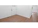 Inviting home foyer with pristine white walls and new, warm-toned wood flooring at 401 Cottonwood Dr, Woodstock, GA 30189