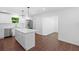 Bright, open kitchen with an island, stainless steel appliances, white cabinets, and stone countertops at 401 Cottonwood Dr, Woodstock, GA 30189