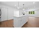 New kitchen island boasting white cabinets and quartz countertop under pendant lights at 401 Cottonwood Dr, Woodstock, GA 30189