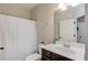 Bathroom with dark vanity, white countertop, and a shower/tub combo at 4405 Donahue Ave, Sugar Hill, GA 30518