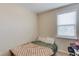 Cozy bedroom features neutral walls, a window, and space for a twin bed at 4405 Donahue Ave, Sugar Hill, GA 30518