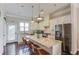 Modern kitchen featuring white cabinets, stainless steel appliances, and granite countertops at 4405 Donahue Ave, Sugar Hill, GA 30518