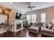 Bright and airy living room with a fireplace, large windows, and hardwood floors at 4405 Donahue Ave, Sugar Hill, GA 30518