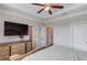 Spacious main bedroom features tray ceiling with fan, TV, and ensuite bathroom at 4405 Donahue Ave, Sugar Hill, GA 30518