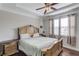 Serene main bedroom featuring tray ceilings, hardwood floors, and ample natural light at 4405 Donahue Ave, Sugar Hill, GA 30518
