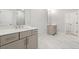 Bathroom with double vanity sinks and modern fixtures, complemented by tile floors and walk-in closet at 233 Retreat Ln, Canton, GA 30114