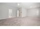 Spacious bedroom with neutral carpet, ceiling fan, and doorways to other rooms at 233 Retreat Ln, Canton, GA 30114