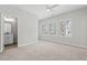 Bedroom features plush carpeting, a ceiling fan, and a connected bathroom at 233 Retreat Ln, Canton, GA 30114