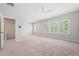 Large bedroom with neutral carpet, windows, and doorway access at 233 Retreat Ln, Canton, GA 30114