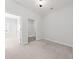 Bedroom with neutral carpet, white walls, and an attached laundry room for convenience at 233 Retreat Ln, Canton, GA 30114