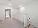 Upstairs hallway with neutral carpet and natural light, leading to other rooms at 233 Retreat Ln, Canton, GA 30114