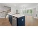 Kitchen island with stainless steel dishwasher and sink overlooking living room and staircase at 233 Retreat Ln, Canton, GA 30114