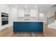 Modern kitchen with white cabinets, stainless steel appliances, and a large blue island at 233 Retreat Ln, Canton, GA 30114
