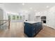 Stylish kitchen with a blue island, white cabinetry, and open access to the living area at 233 Retreat Ln, Canton, GA 30114