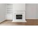 Elegant fireplace with white mantle and built-in shelving, complemented by hardwood floors at 233 Retreat Ln, Canton, GA 30114