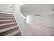Carpeted staircase leads to a spacious, open-concept living area with a ceiling fan at 233 Retreat Ln, Canton, GA 30114