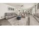Open-concept living room with hardwood floors, neutral decor, and a view into the dining and kitchen areas at 372 Garnet Dr, Acworth, GA 30101
