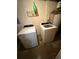 Functional laundry room with white washer and dryer, and essential storage solutions at 405 Fairburn Sw Rd # 64, Atlanta, GA 30331