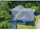 Aerial view showcasing the expansive roof, lush greenery, and mature trees surrounding the property at 4635 Tims Pl, Snellville, GA 30039
