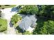 An aerial view of the home featuring mature trees, large yard, and concrete patio at 4635 Tims Pl, Snellville, GA 30039