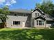 Spacious backyard with lush lawn, mature trees, and a patio perfect for entertaining at 4635 Tims Pl, Snellville, GA 30039