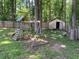 Backyard featuring a wooden playset, storage shed, and a classic wooden perimeter fence at 4635 Tims Pl, Snellville, GA 30039