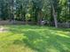 Expansive lawn featuring a play set, storage shed, and wooden fence at 4635 Tims Pl, Snellville, GA 30039