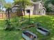 Backyard featuring a garden with raised beds, black gazebo, and perimeter wooden fence at 4635 Tims Pl, Snellville, GA 30039