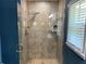 Modern shower with glass door, dual shower heads, tiled walls, and great natural light at 4635 Tims Pl, Snellville, GA 30039