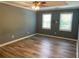 Nice bedroom with new flooring, ceiling fan, and two windows for natural light at 4635 Tims Pl, Snellville, GA 30039