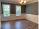 Bright dining room with gray walls, white trim, wood floors, and a classic chandelier at 4635 Tims Pl, Snellville, GA 30039